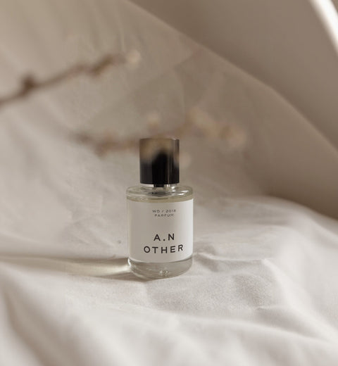 A.N. Other WD/2018 Parfum 50ML bottle on soft ivory linen with soft ivory wall and botanical shadow in the foreground.