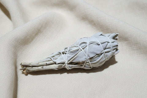 California White Sage bundle resting on neutral linen background.