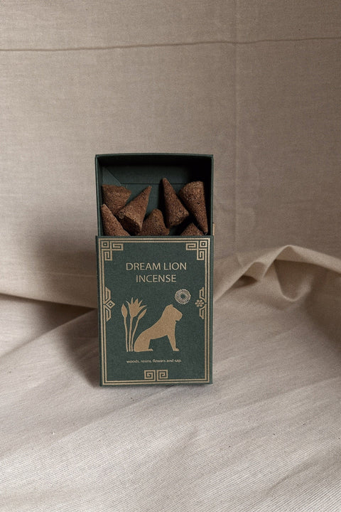 Dream Lion Incense Mayan Copal and Desert Sage box with incense cones on neutral linen background.