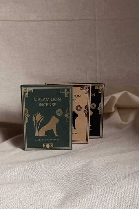 Dream Lion Incense three scent boxes styled together on neutral linen background.