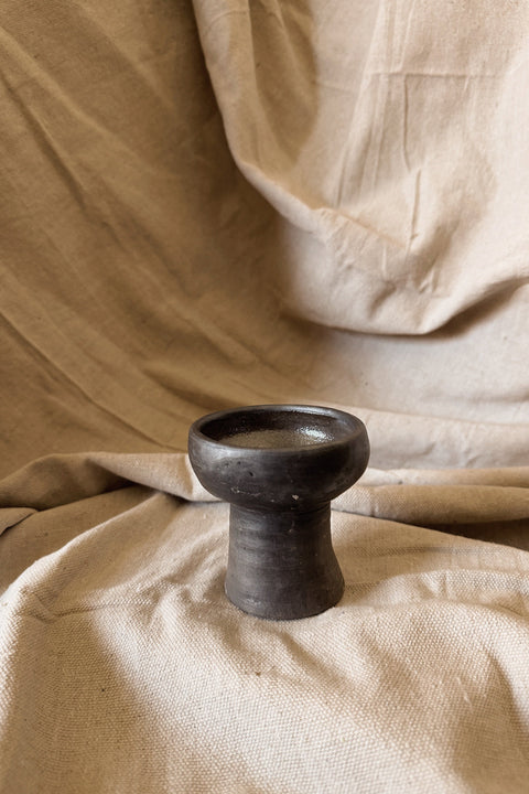 Side view of Copalerita clay burner on neutral linen background.